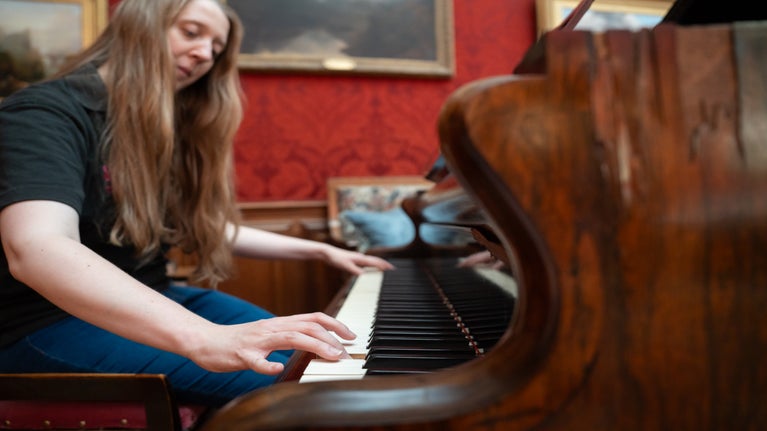 A member of the Cragside team plays the Broadwood piano